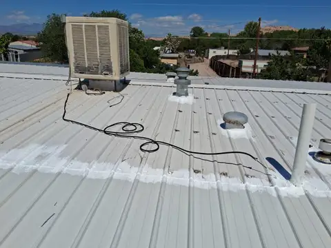 CyJ Tree Service And Handyman repairing and sealing a metal roof near Espanola, NM