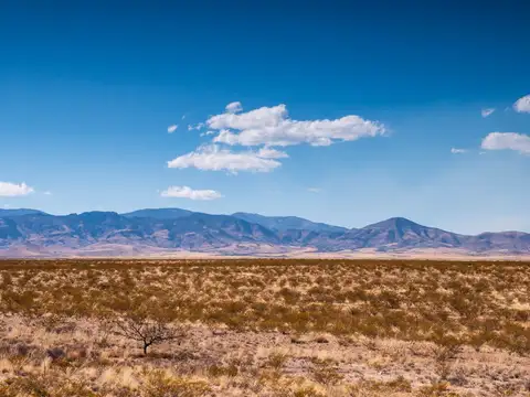 High desert landscape with distant mountains in northern New Mexico